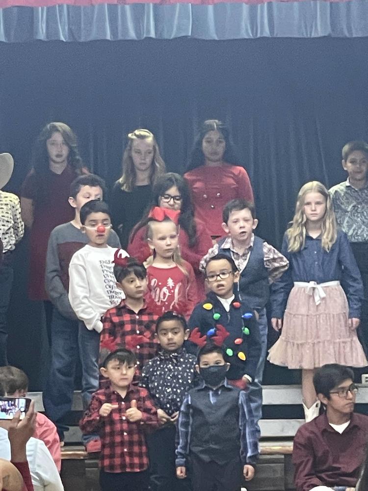 Valentine students sing Christmas carols to an audience of parents and teachers. 